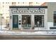 Charming brick commercial building with large windows and a bright teal door at 930 Acoma St # 420, Denver, CO 80204