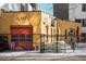 Yellow building with 'PLANT garage' signage, fenced perimeter, and industrial elements at 930 Acoma St # 420, Denver, CO 80204