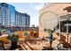 Outdoor patio with city views, potted plants, and ample seating space at 930 Acoma St # 420, Denver, CO 80204