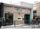 Exterior of La Stella Ristorante featuring a stone accent wall and dark green door at 930 Acoma St # 420, Denver, CO 80204