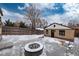 Wide backyard view shows stone fire pit and snow-covered yard at 475 S Race St, Denver, CO 80209