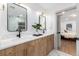 Bathroom with double sink vanity, modern fixtures, and a view into an adjacent bedroom at 475 S Race St, Denver, CO 80209