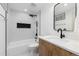 Well-lit bathroom showcases modern design with white marble tile, sleek fixtures, and wooden vanity at 475 S Race St, Denver, CO 80209