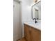 Bathroom features a modern sink with a wood grain cabinet and a door leading to another room at 475 S Race St, Denver, CO 80209