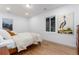 Bright bedroom featuring hardwood floors, natural light, and unique artwork at 475 S Race St, Denver, CO 80209