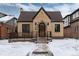 Charming brick home featuring a stone entryway, well-maintained landscaping and a classic peaked roof design at 475 S Race St, Denver, CO 80209