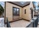 Cozy front patio perfect for outdoor relaxation with brick accents and a wrought iron railing at 475 S Race St, Denver, CO 80209