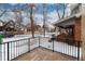 Quaint front porch with iron railing providing a cozy outdoor space on a snow covered lawn at 475 S Race St, Denver, CO 80209