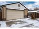 Image of the garage featuring a clean cream-colored door and snowy driveway at 475 S Race St, Denver, CO 80209