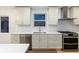 Close-up of modern kitchen with white cabinets, stainless steel appliances and white countertops at 475 S Race St, Denver, CO 80209