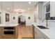 Beautiful kitchen featuring an island with a built-in microwave and modern countertops, and an archway to living room at 475 S Race St, Denver, CO 80209