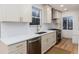 Modern kitchen with white cabinets, stainless steel appliances, and white countertops at 475 S Race St, Denver, CO 80209