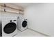 Bright laundry room equipped with modern washer and dryer, complemented by functional wooden shelving at 475 S Race St, Denver, CO 80209