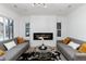 Bright living room featuring modern decor, a stylish fireplace, and large windows for ample natural light at 475 S Race St, Denver, CO 80209