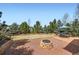 Private backyard with mature trees, well-maintained lawn, paver patio and cozy fire pit at 17456 Quarry Way, Monument, CO 80132