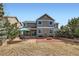 Home's backyard features a spacious patio, fire pit, well-maintained lawn and lovely landscaping at 17456 Quarry Way, Monument, CO 80132
