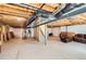 Unfinished basement offering potential for customization, plus a leather couch and lounge chair at 17456 Quarry Way, Monument, CO 80132