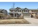 Inviting two-story home with neutral siding, charming front porch and well-manicured lawn at 17456 Quarry Way, Monument, CO 80132