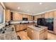 Well-equipped kitchen with granite countertops, stainless appliances, ample cabinet space and kitchen island at 17456 Quarry Way, Monument, CO 80132