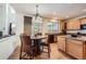Eat-in kitchen featuring wood cabinets, granite counters, stainless appliances and a pendant light at 17456 Quarry Way, Monument, CO 80132