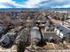 An aerial view showcases the property and surrounding neighborhood with mountain views in the distance at 2819 S Bannock St, Englewood, CO 80110