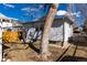 Here is a shot of the property's backyard and home with a prominent tree in the middle of the yard at 2819 S Bannock St, Englewood, CO 80110