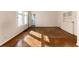 Light-filled living area featuring beautiful hardwood floors, built in storage, and bright neutral walls at 2819 S Bannock St, Englewood, CO 80110