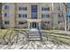 Charming brick apartment building with well-maintained landscaping and inviting front entrance with blue railings at 85 N Ogden St # 13, Denver, CO 80218