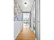Hallway with decorative wallpaper and wainscoting leading to the living room and bathroom at 85 N Ogden St # 13, Denver, CO 80218