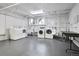 Spacious laundry room featuring rows of modern washers and dryers, plus wash basins and folding table at 85 N Ogden St # 13, Denver, CO 80218