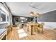 Living area showcasing hardwood floors, ladder, window, and seamless flow into the dining space at 85 N Ogden St # 13, Denver, CO 80218