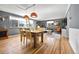 Open-concept living area with a large window, hardwood floors, dining table and comfortable furniture at 85 N Ogden St # 13, Denver, CO 80218