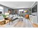 Bright living room features a comfortable gray sofa, unique décor, large window and hardwood floors at 85 N Ogden St # 13, Denver, CO 80218
