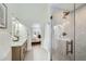 Bathroom with double vanity, walk-in shower, and bedroom view at 2133 S Parfet Dr, Lakewood, CO 80227