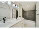 Modern bathroom with double vanity and tub shower combo at 2133 S Parfet Dr, Lakewood, CO 80227