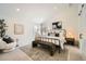 Main bedroom with large windows, plush carpet, and a metal framed bed at 2133 S Parfet Dr, Lakewood, CO 80227