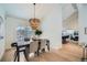 Bright dining room with a large chandelier and hardwood floors at 2133 S Parfet Dr, Lakewood, CO 80227