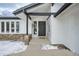 Modern front entrance with a black door and stone accents at 2133 S Parfet Dr, Lakewood, CO 80227