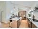 Modern kitchen with island, stainless steel appliances, and light wood cabinets at 2133 S Parfet Dr, Lakewood, CO 80227