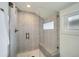 Spa-like shower with glass enclosure and gray tile at 2133 S Parfet Dr, Lakewood, CO 80227