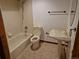 Clean bathroom featuring a shower-tub combo, toilet, pedestal sink, and neutral tiling at 2477 S Oakland Cir, Aurora, CO 80014