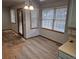 Bright dining area featuring plenty of windows, new vinyl floors, and overhead lighting at 2477 S Oakland Cir, Aurora, CO 80014
