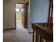 Hallway view leading to a bathroom, showcasing neutral walls and trim detail at 2477 S Oakland Cir, Aurora, CO 80014