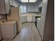 Well-lit kitchen with light blue cabinets, modern appliances, and plank flooring at 2477 S Oakland Cir, Aurora, CO 80014