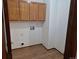 Laundry room with overhead cabinets, flooring, and laundry hookups at 2477 S Oakland Cir, Aurora, CO 80014