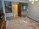 Spacious living room featuring stairs, doorway, and hardwood floors, ready for renovation at 2477 S Oakland Cir, Aurora, CO 80014