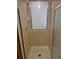 Shower stall features tan tiling, a window and a shower head with chrome hardware at 2477 S Oakland Cir, Aurora, CO 80014