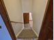 Carpeted staircase leading to the basement with a wooden handrail at 2477 S Oakland Cir, Aurora, CO 80014