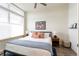 Bedroom with a modern bed frame, mountain artwork, and large bright windows offering natural light at 928 Cimarron Dr # C, Lafayette, CO 80026