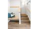 Bright entryway with coat hooks, a wooden bench, and stairs leading to the upper level at 928 Cimarron Dr # C, Lafayette, CO 80026